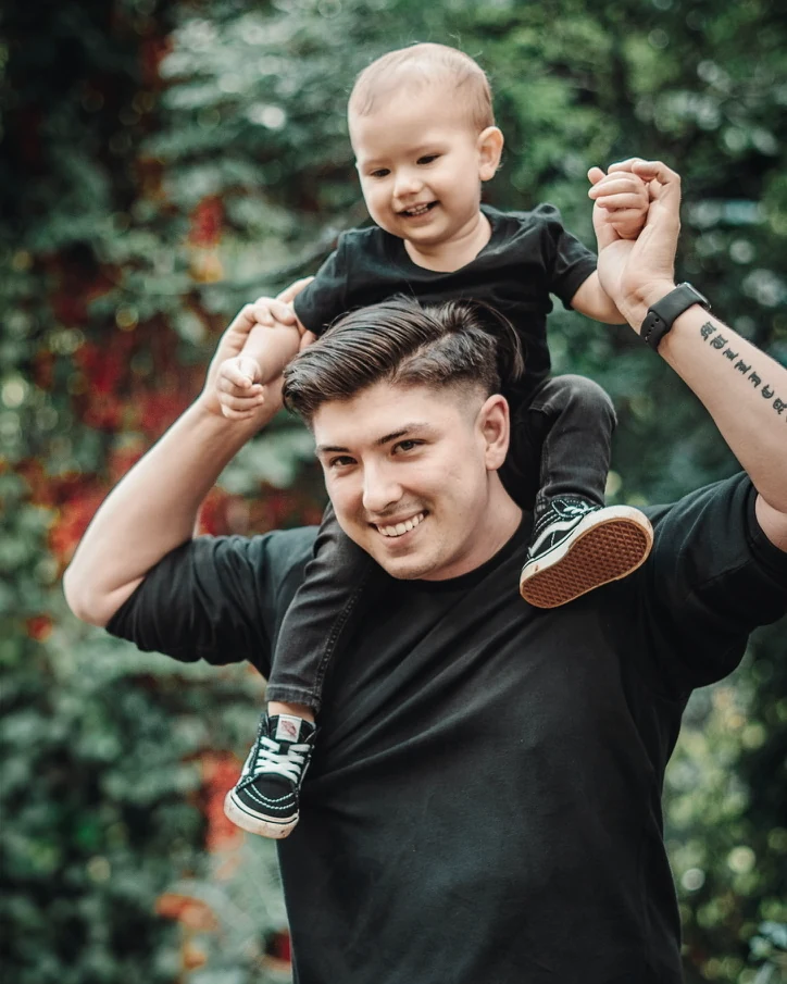 Christian Mullican with his son on his shoulders